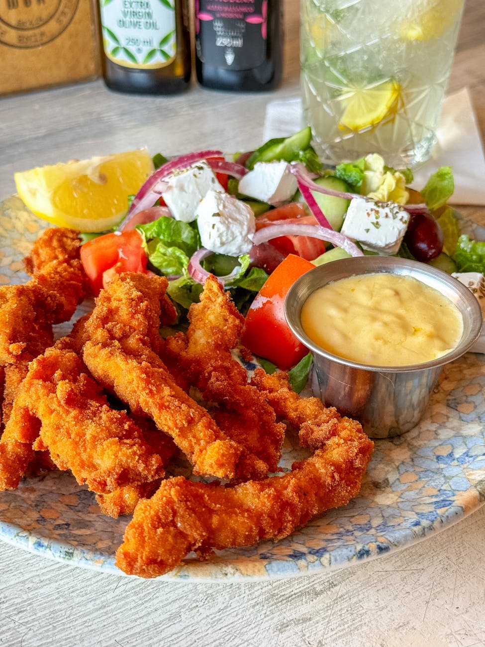 a plate with fried chicken and salad on it