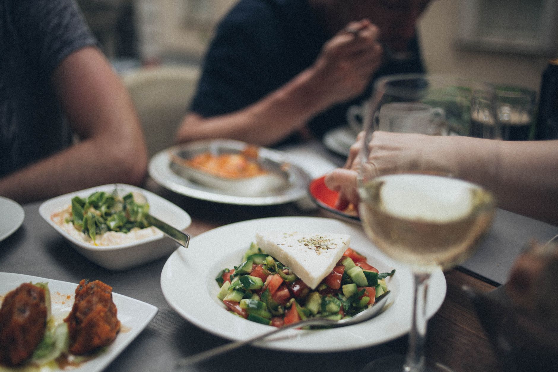 cooked dishes on table beside clear wine glass