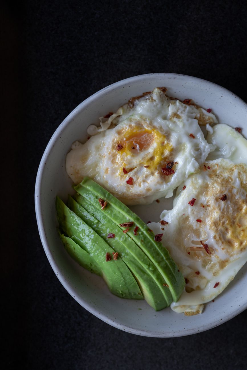 healthy breakfast bowl with avocado and eggs