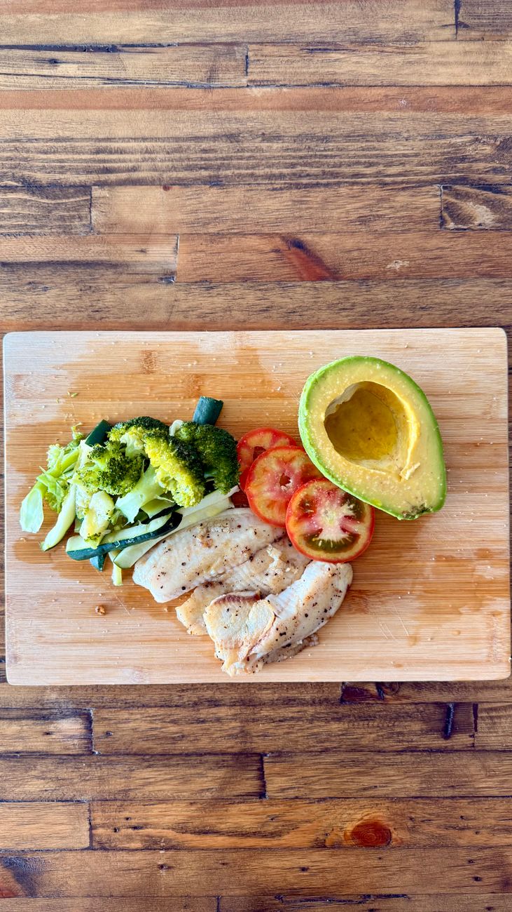 healthy meal with chicken and vegetables on wooden table