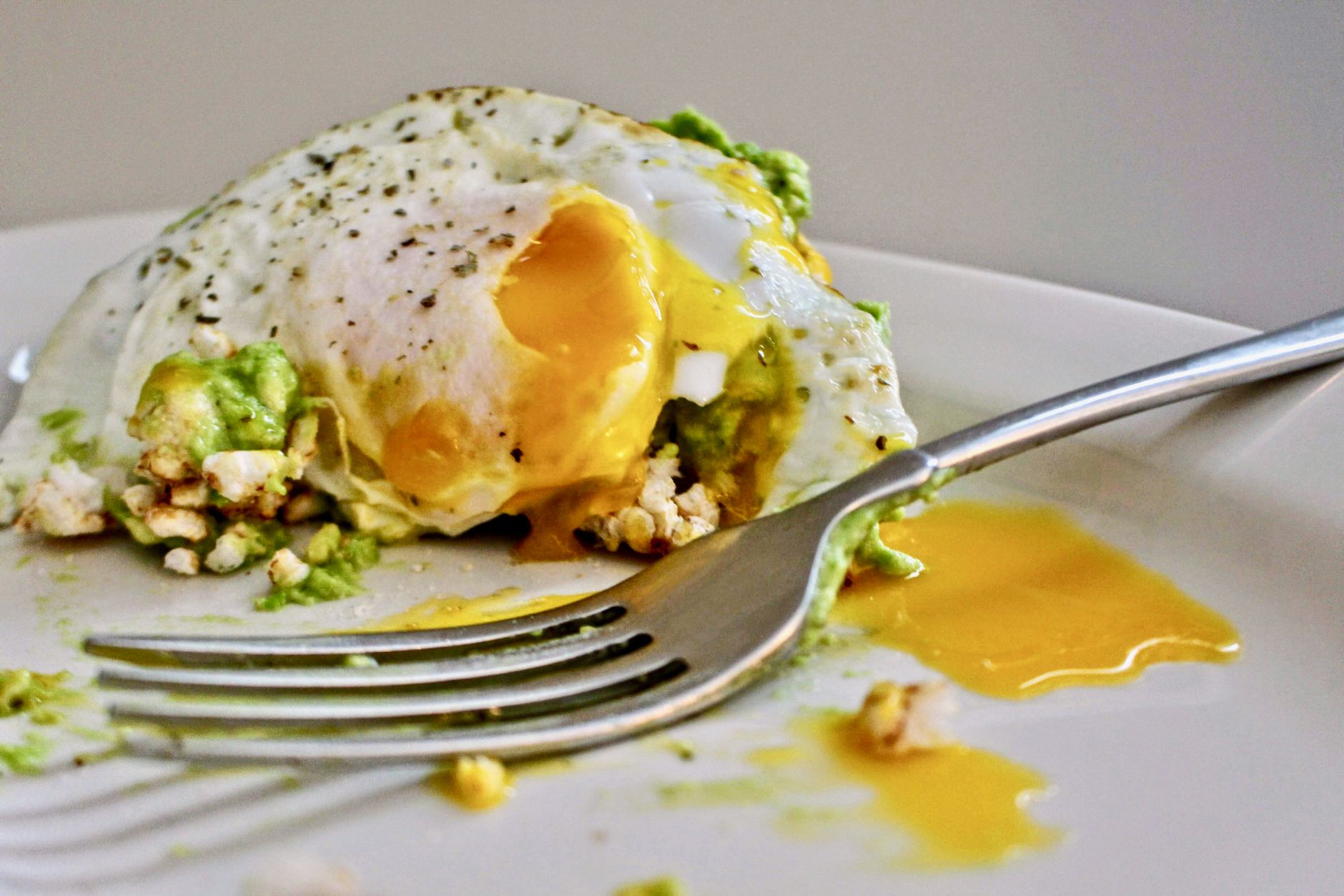 avocado with fried egg with runny yolk