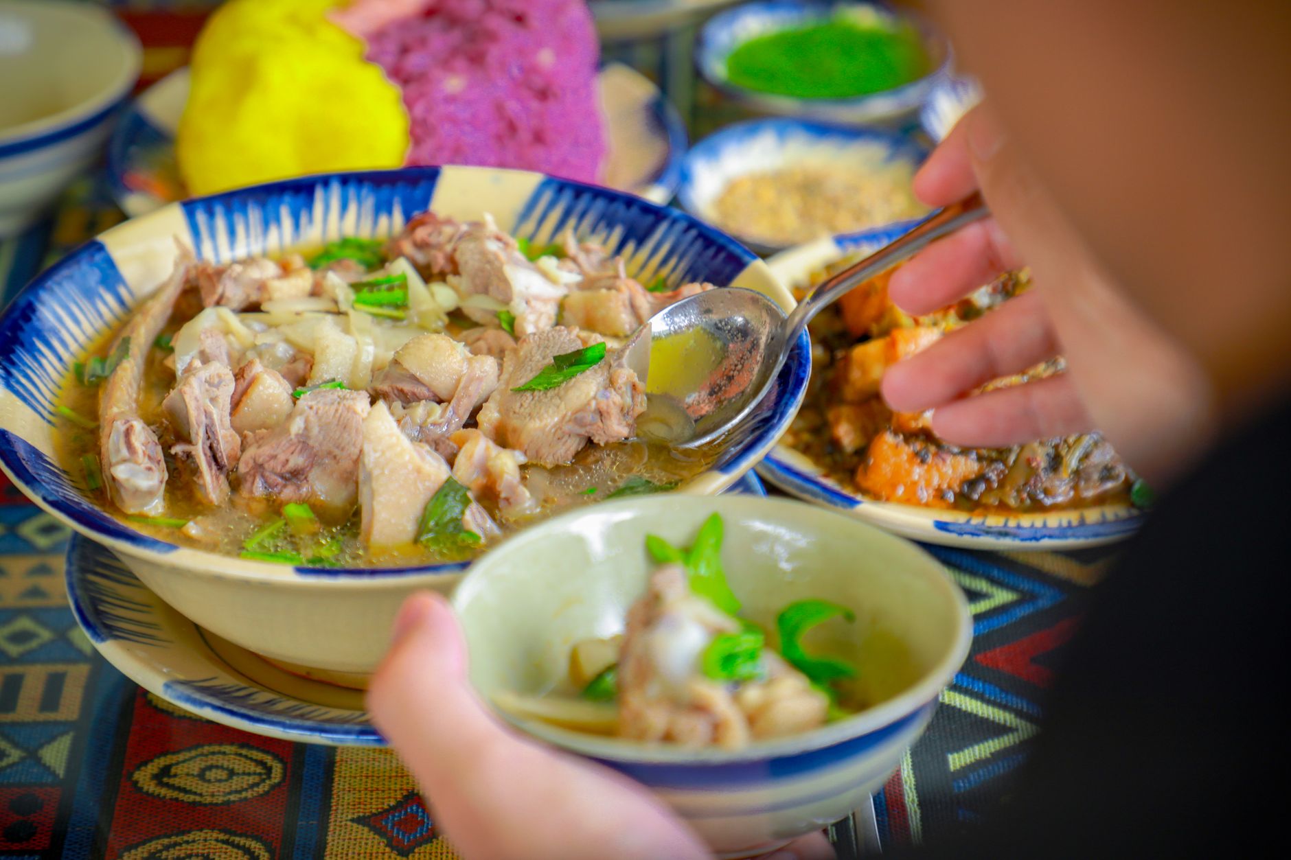 person eating delicious chicken soup
