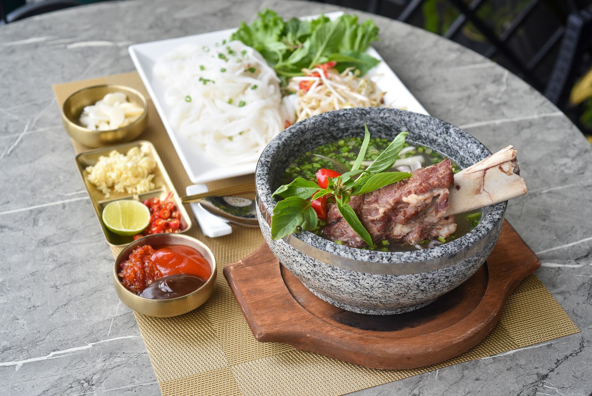 a bowl of soup with meat and vegetables on a table
