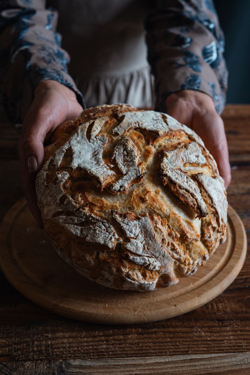 freshly baked rustic bread on wooden table