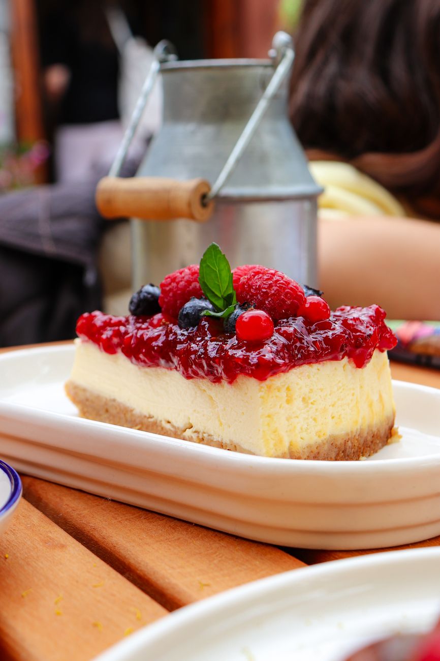 delicious berry topped cheesecake on patio table